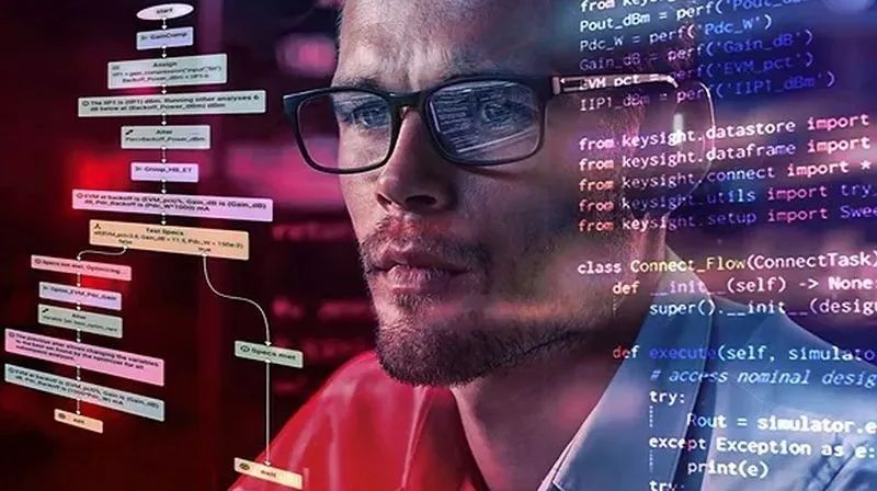 Engineer viewing workflow diagrams and source code on computer screens